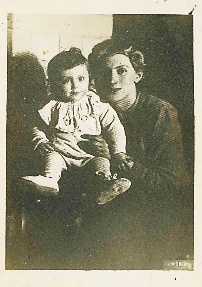 The same child on his mother's lap: Mendele held by Pesse Rochel, her face beside his, both looking at the camera.